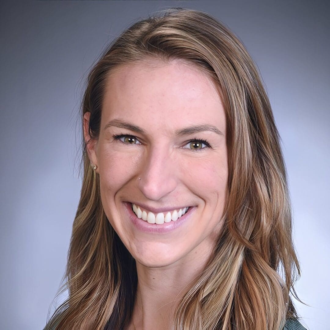 Smiling woman with long brown hair.